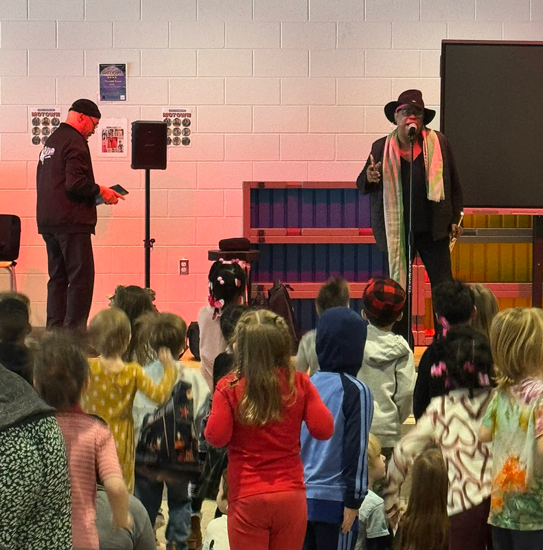 performers dance on stage in Ferndale Lower Elementary audi-teria