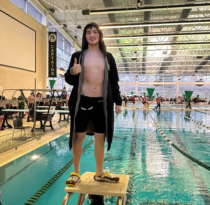 swim team poses after victory