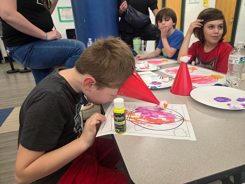students in Cub Scouts at FUEL practice  using assistive devices to learn empathy for persons living with disabilities