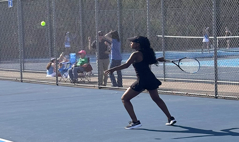 girls tennis plays a match