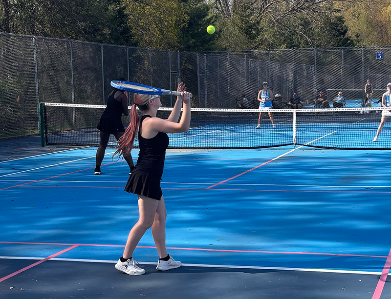 girls tennis plays a match