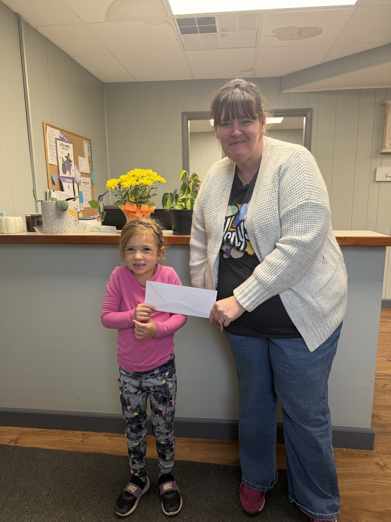 Julia and student with donation check 