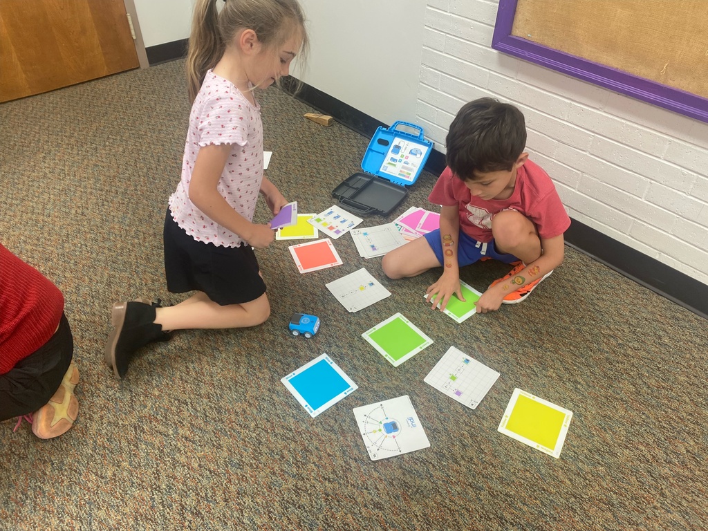 First graders learn from NPPD about computer programming.