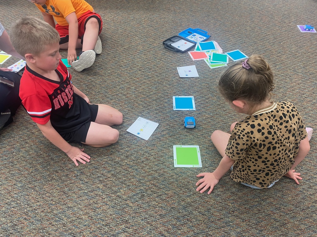 First graders learn from NPPD about computer programming.
