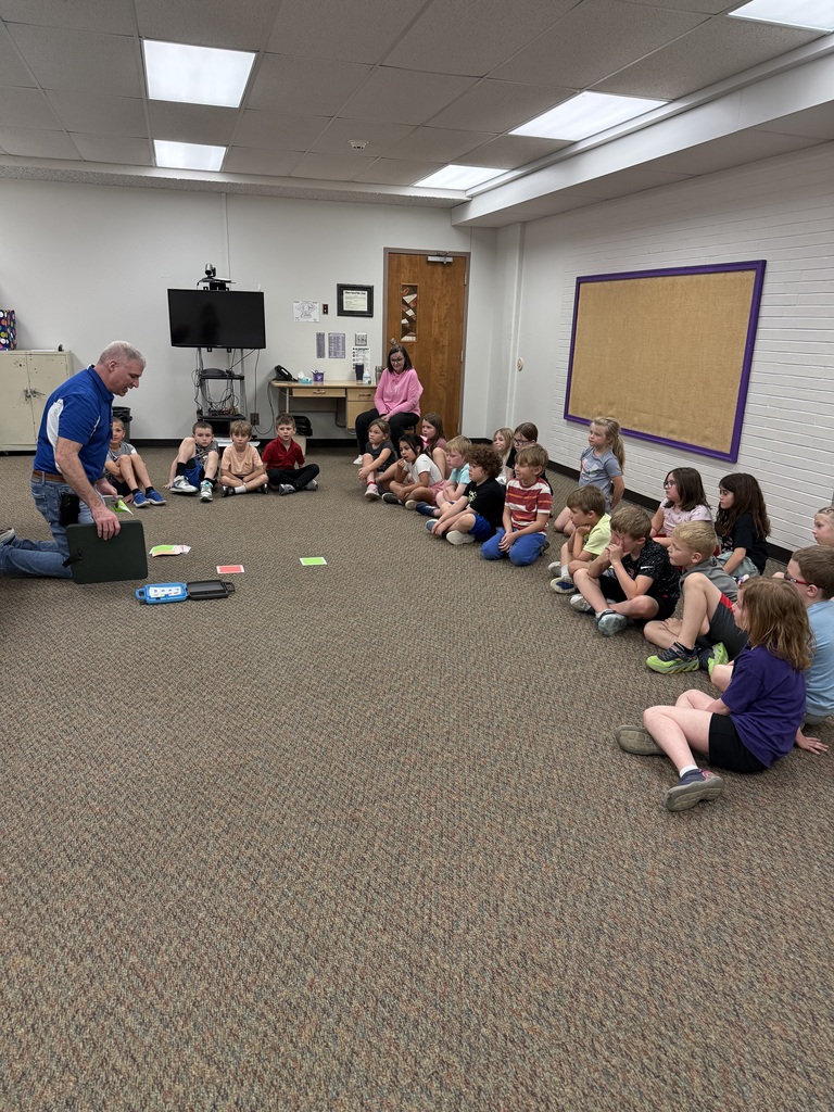 First graders learn from NPPD about computer programming.