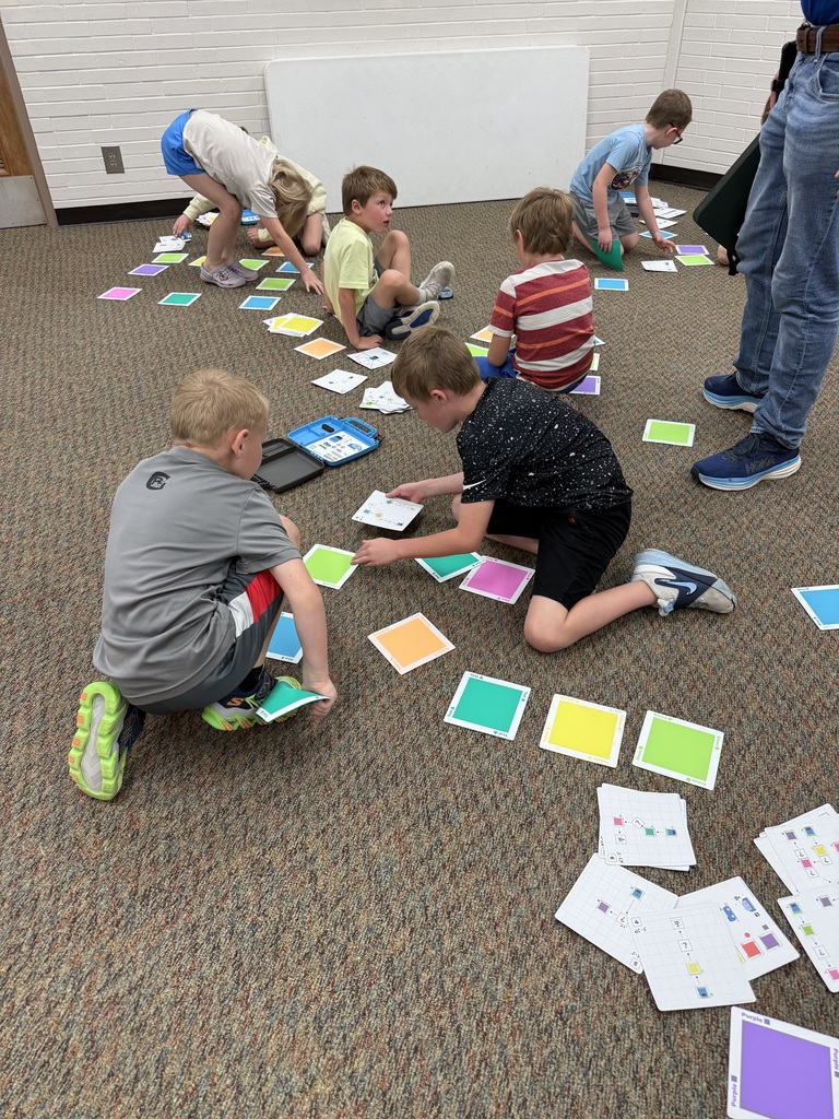 First graders learn from NPPD about computer programming.