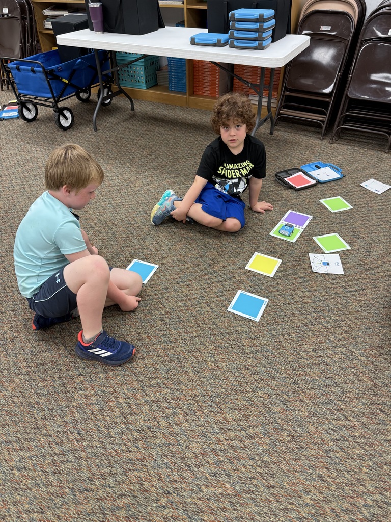 First graders learn from NPPD about computer programming.