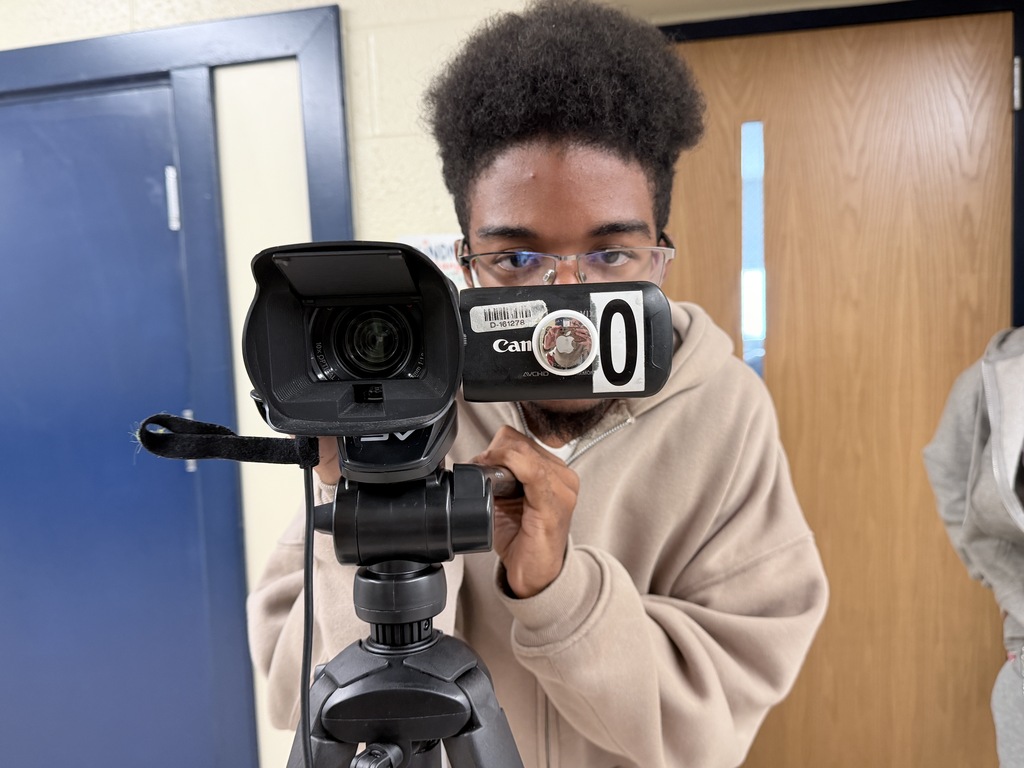 A student practices using the camera