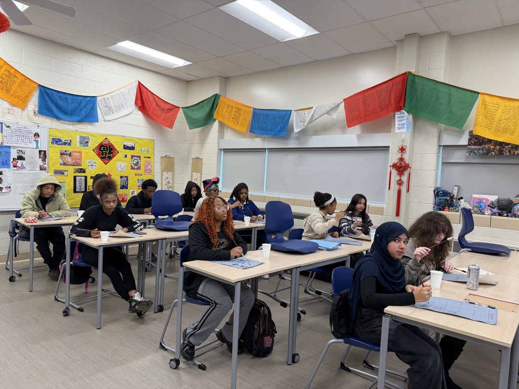FHS students try out calligraphy in class.