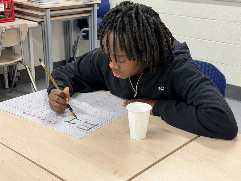 CMS students try out calligraphy in class.