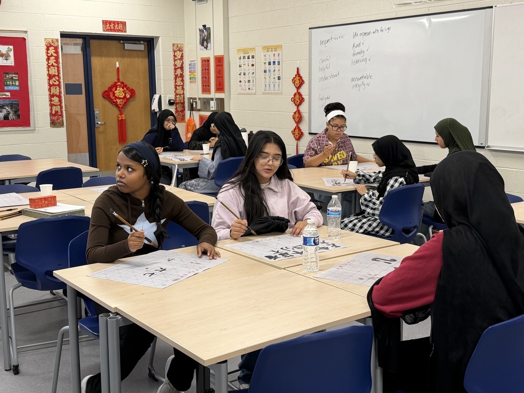 CMS students try out calligraphy in class.