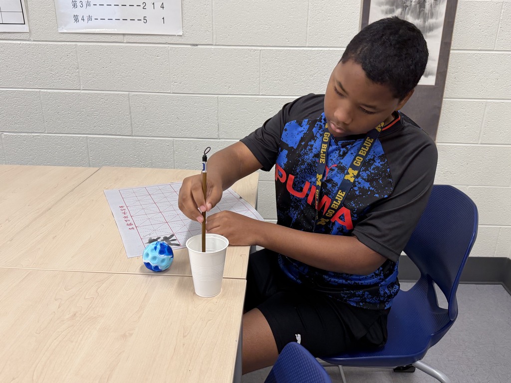 CMS students try out calligraphy in class.