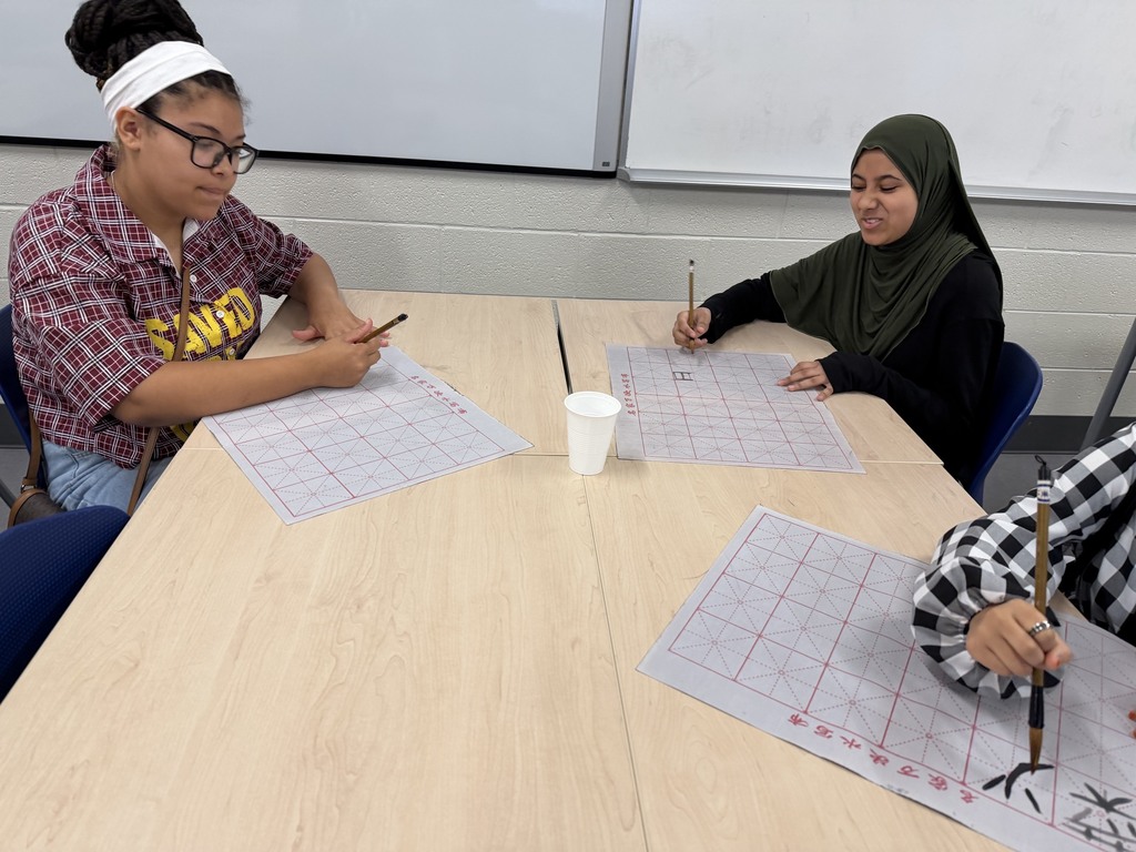 CMS students try out calligraphy in class.