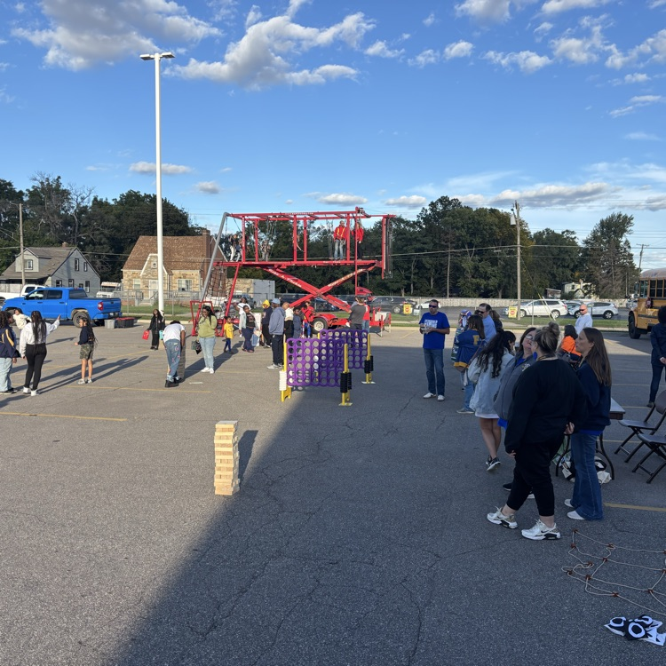 families enjoying games and the ropes course at family fun day
