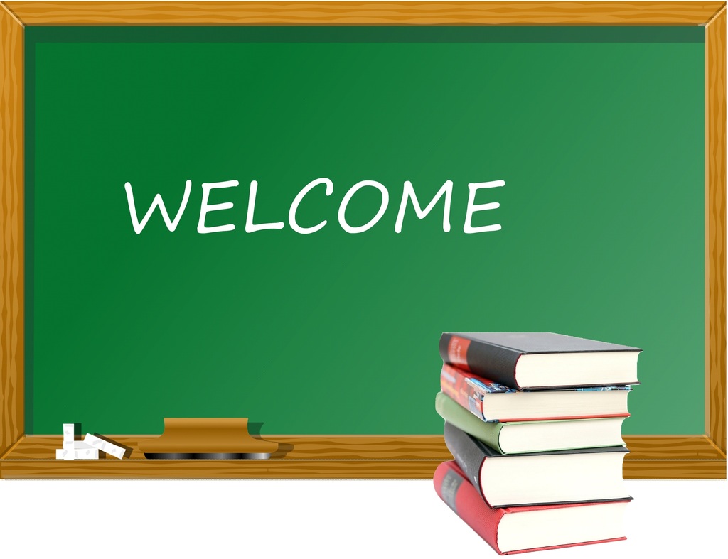 The word welcome is written on a blackboard with books in the foreground