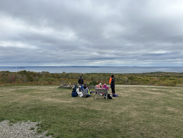 students getting instruction on how to build a kite