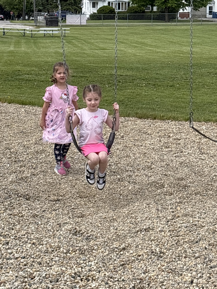 friends pushing friends on the swing