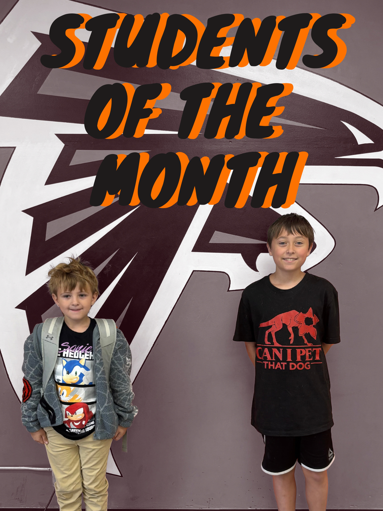 Ryker and Liam post by the Falcon mural for their student of the month photos.