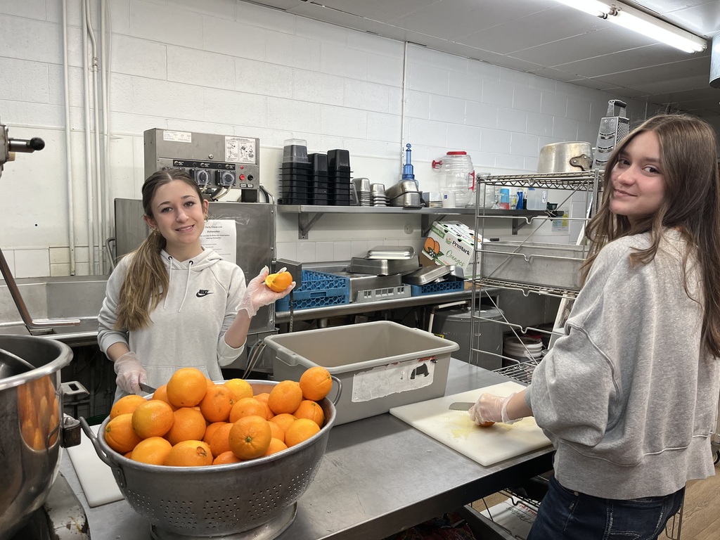 Emoree and Maddy cutting oranges