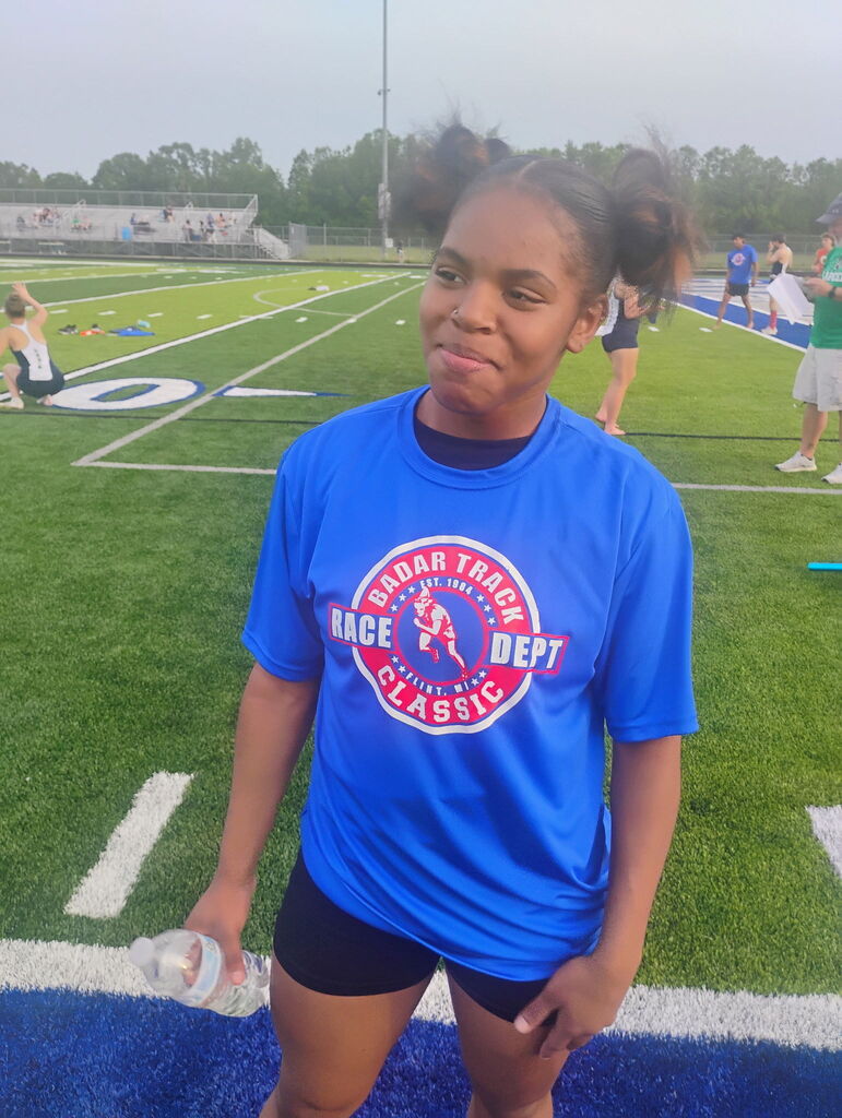 Freshman Mariam Bilal continues to impress on the track, showcasing her earned shirt after placing in the 100-meter dash—a great accomplishment in a standout performance.