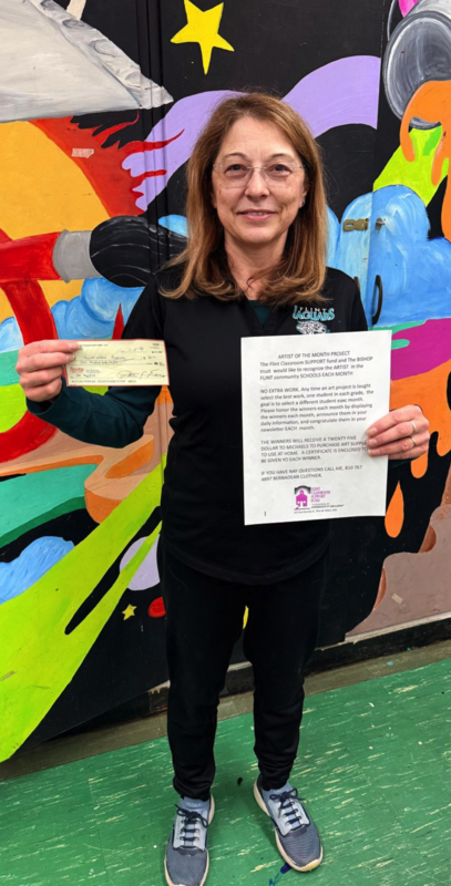 Mrs. Lossing holding a check