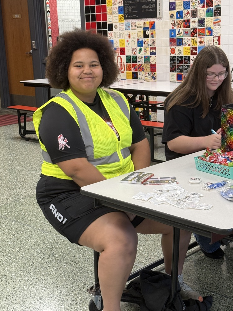 JaNay encouraging students to sign pledge cards