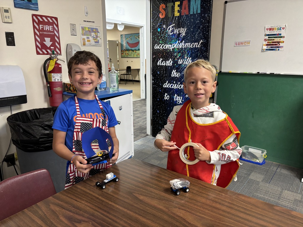 second graders building lego cars at table