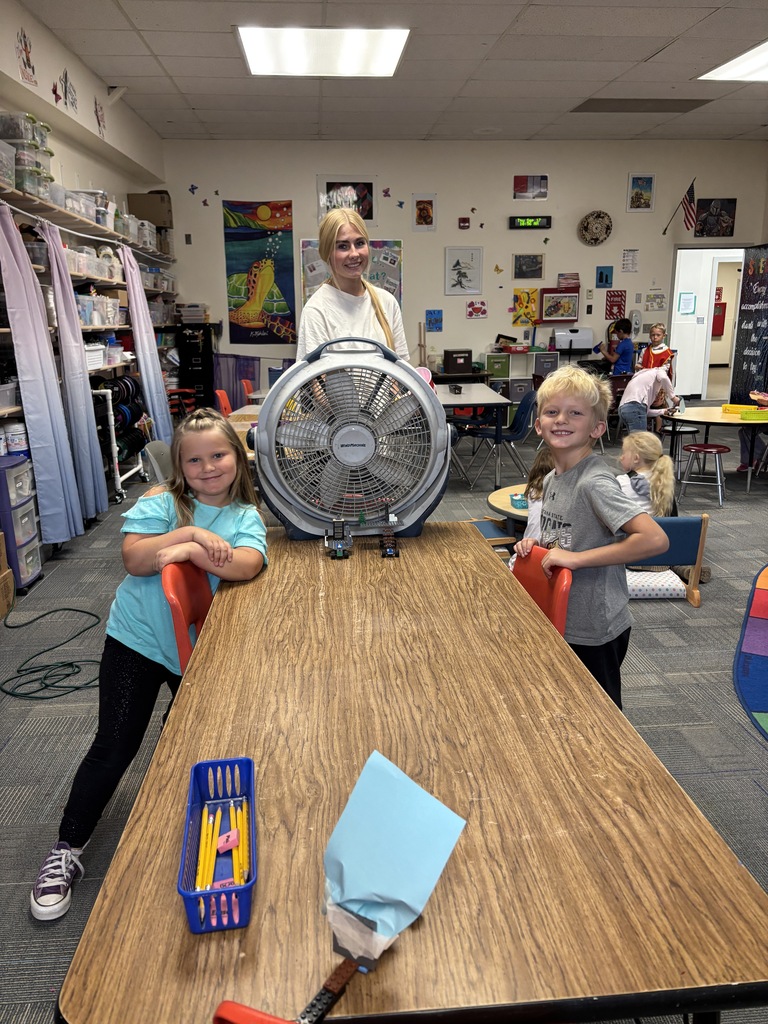 Students racing lego cars with fan