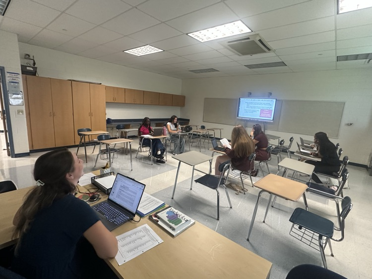 High school senior sitting at desks while Teacher instructed them on college writing essays