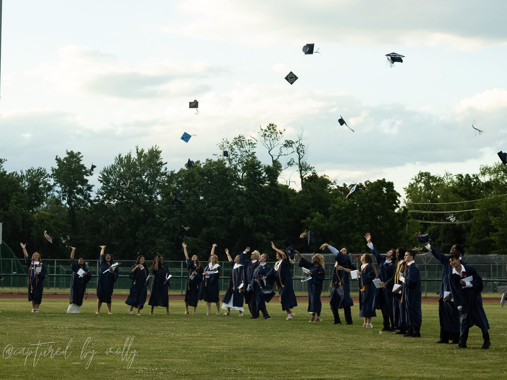 pic of HS graduates throwing caps 2026