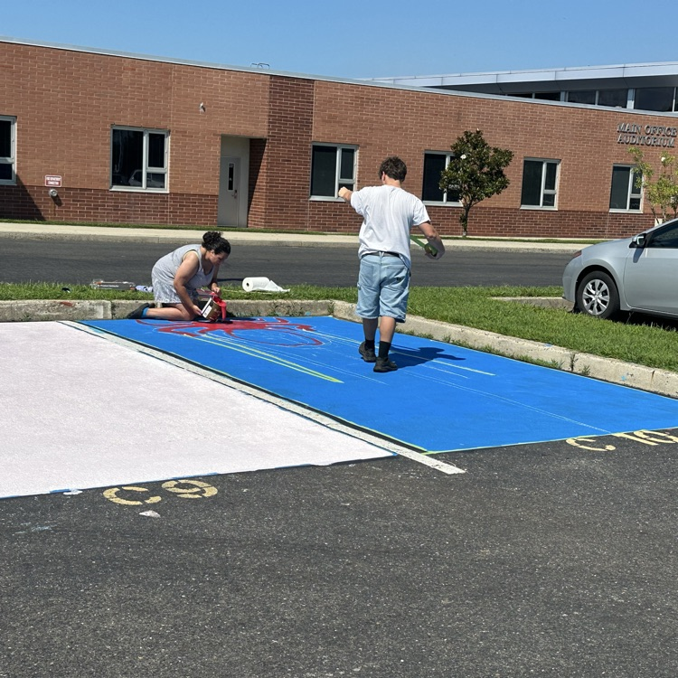 Picture of two kids, painting a parking spot