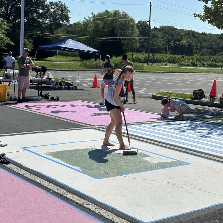 Picture of a girl painting a parking spot