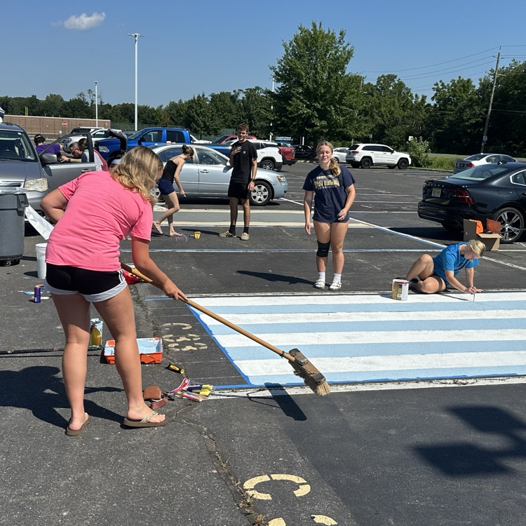 Picture of a girl painting a parking spot