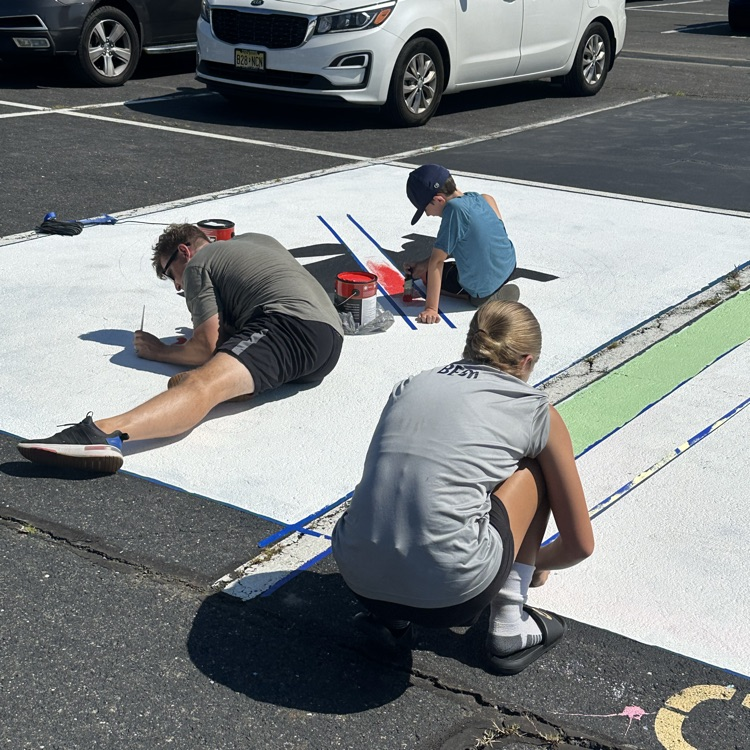 Picture of a girl painting a parking spot