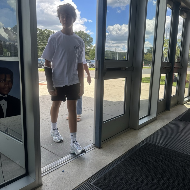 Picture of boy walking in the door at freshman orientation