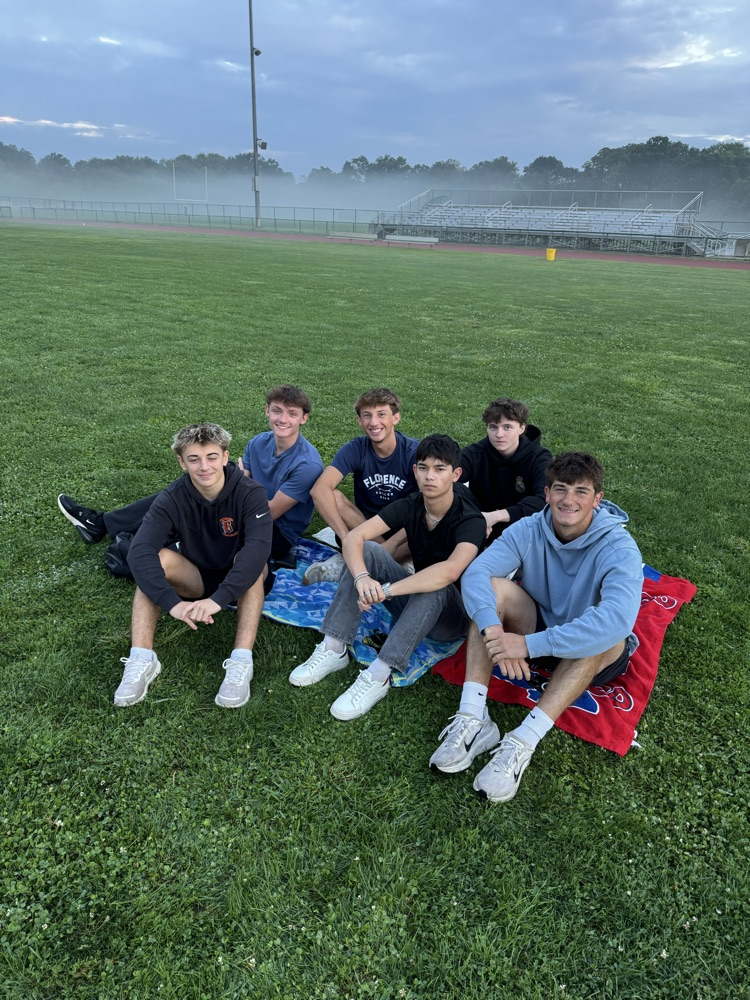 Picture of a group of kids sitting down in the grass