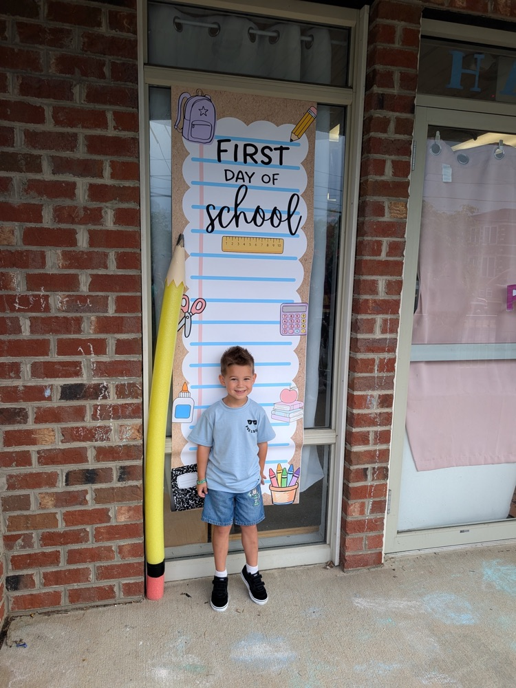 Preschool student standing in front of first day, Sign