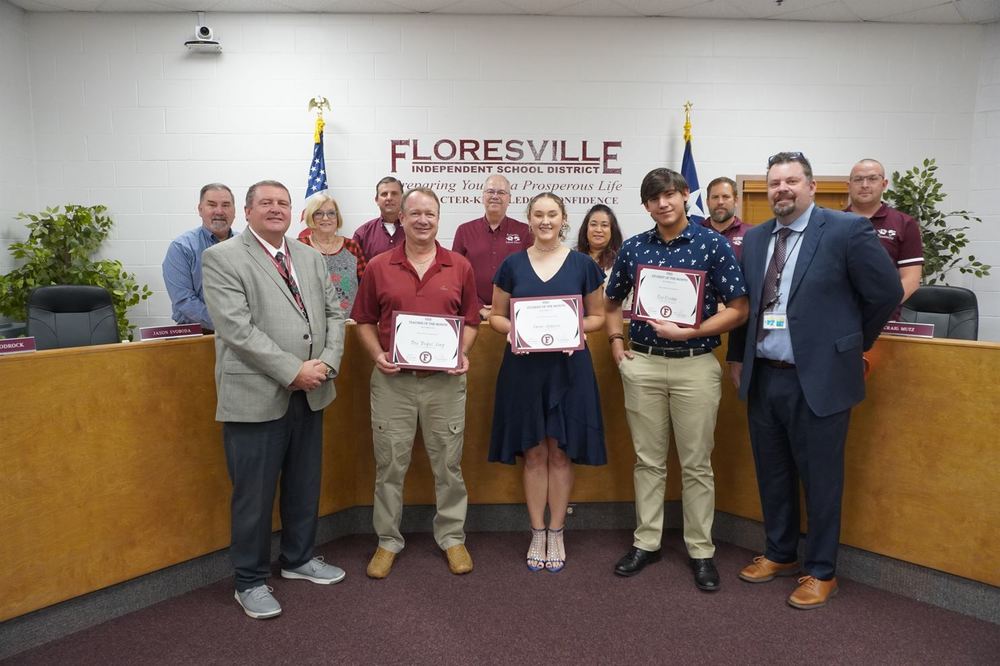 Students and teacher holding certificate in front of board members
