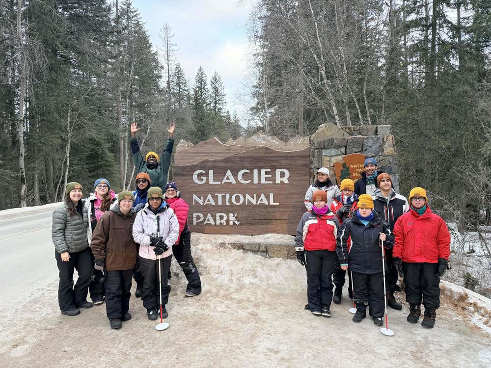 BHS Students posing in front of Glacier National Park Sign