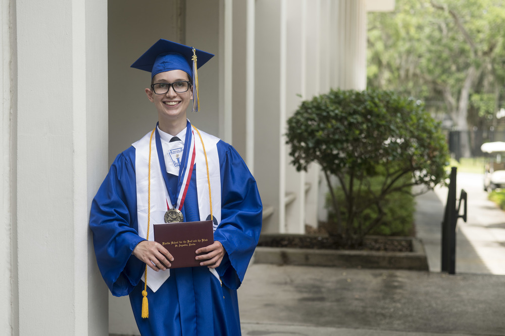 Logan Cake Holding Diploma after Graduation