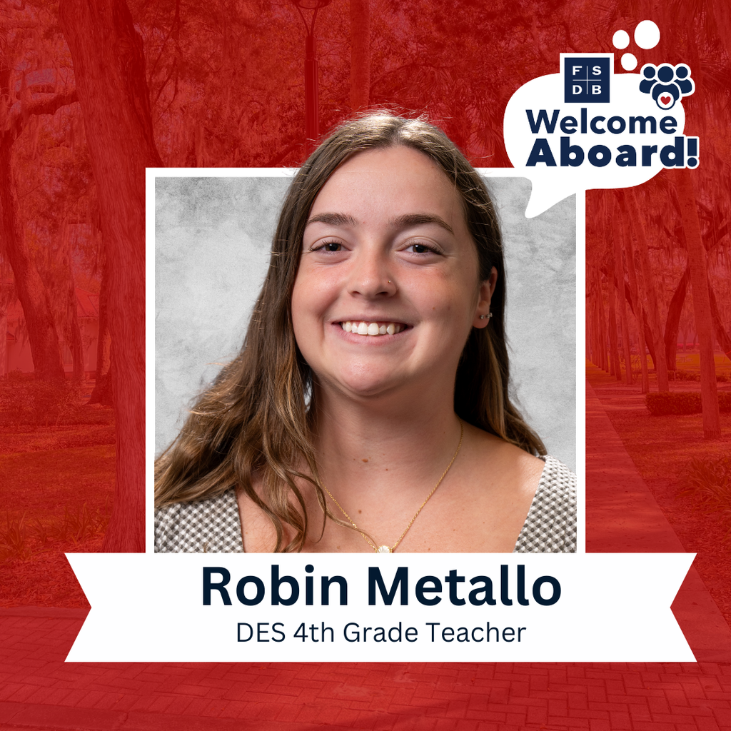 Robin is wearing a black checkered shirt smiling for her photo with a silver backdrop and red background. Below the photo says "Robin Metallo, DES 4th Grade Teacher"