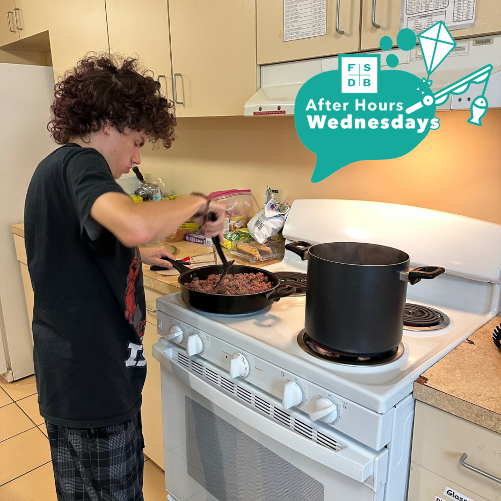 A student is cooking ground beef inside the kitchen in the residential halls.