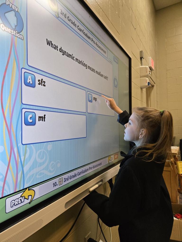 Aubrey makes a selection to her Quaver Question, "What dynamic marking means medium soft?" Her selection is mp, which is correct!