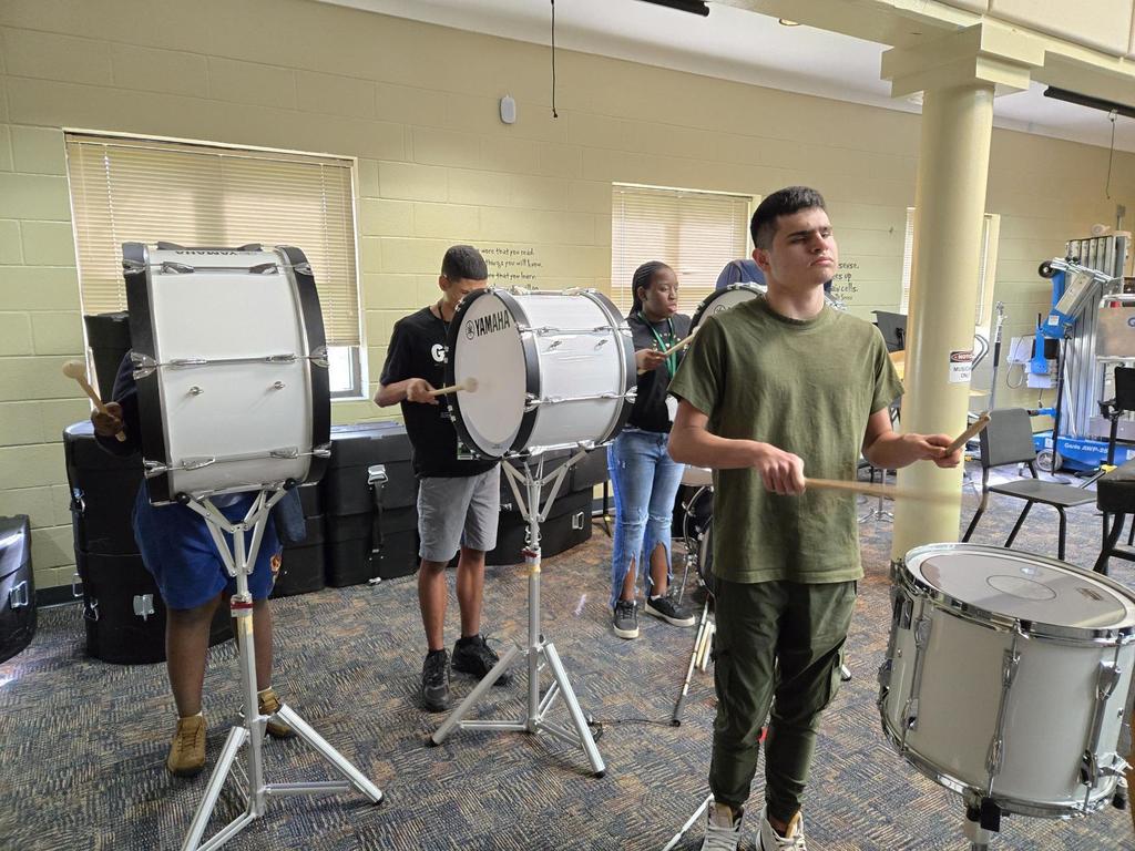 Facundo, Carlos and Shanteria practice during Drumline.