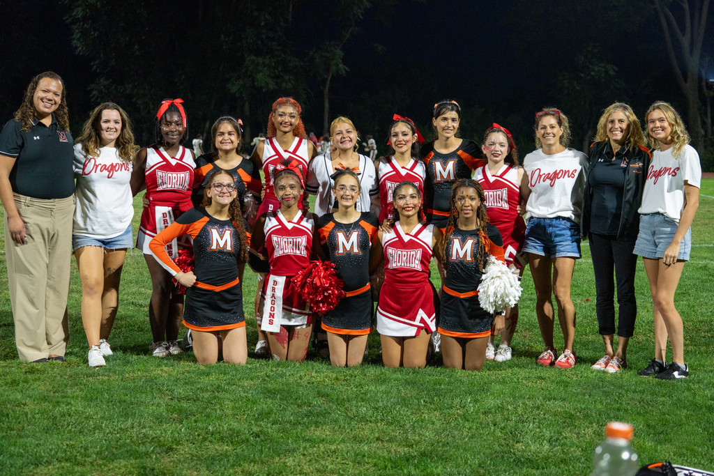MSD and FSDB cheerleading team and coaches smile for a photo on the field. 