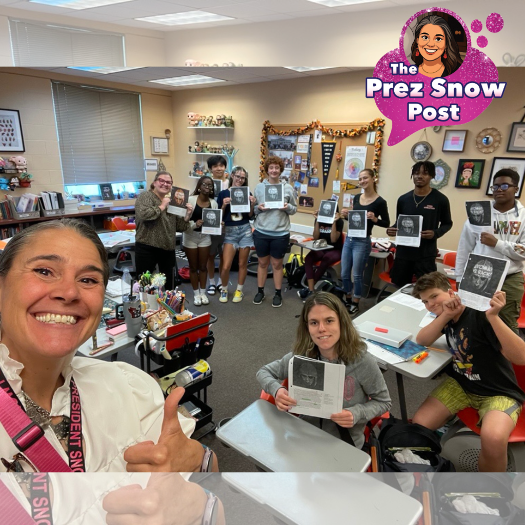 President Snow is smiling for a selfie with a thumbs up with the deaf high school seniors English class inside the classroom in Pope. 