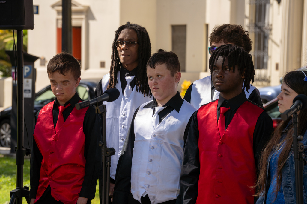 A close-up of a few boy students wearing red and white vests outside the plaza in downtown St. Augustine. 