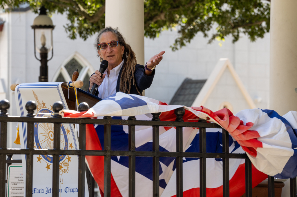 A photo of an St. Augustine member making a speech introducing the choir. 