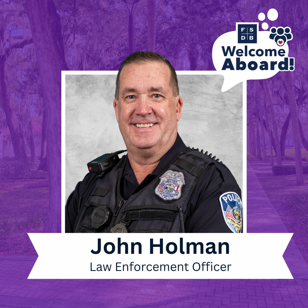 John is wearing his officer uniform smiling for a photo with a silver backdrop and purple background. Below the photo is a white text box that says "John Holman, Law Enforcement Officer"
