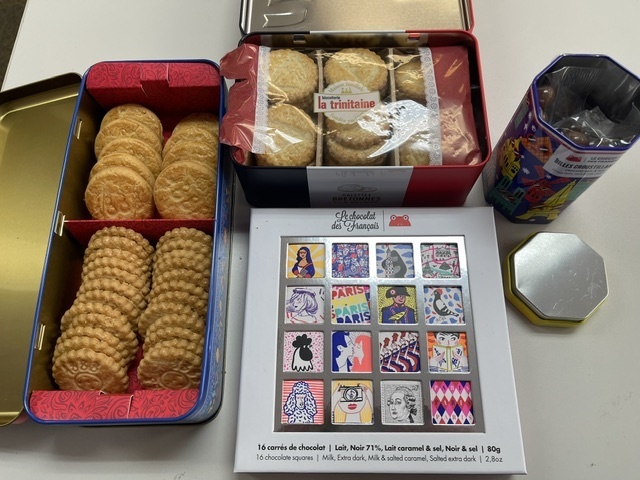 Photo of cookies, chocolates, tactile graphics and braille that he had brought back home to share with his students. 